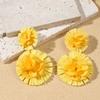 Aretes de isla hechos a mano de girasol de rafia y pasto, aretes de flores grandes exagerados de personalidad junto al mar, venta al por mayor de aretes