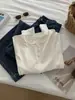 Elegante y suave, camiseta modal de manga larga adelgazante para mujer, otoño 2026, suave y acogedora, con un pequeño cuello en V y botones de concha, camiseta básica