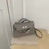 Moda Outono Novo Estilo Exquisite Bolsa de Mão Feminina Pequena Design de Nicho Toque de Luxo Bolsa Kelly Ombro Único Transversal Pequena Quadrada