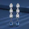 Joia Huabi nova para outono e inverno, cobre banhado a ouro, corindo vermelho simulado, cristal azul, separação de cor ouro preto, pedra de brinco 6*9
