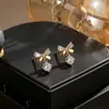 Aretes de plata pura 999 con forma de lazo y circonita para mujer, diseño de nicho, lujo ligero, sensación de alta gama, accesorios para orejas versátiles y simples al por mayor