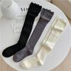 Nueva moda con costuras de color sólido estilo Maillard para niña con botas por encima de la rodilla y calcetines altos
