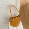 Bolso de axila vintage de alta gama para mujer, nuevo bolso de hombro con patrón tejido de lujo ligero para el verano 2026, bolso tipo cubo
