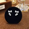 Pendientes de Lazo de Diamante Brillante Microincrustado de Lujo Ligero con Perlas para Mujer, Diseño de Nicho, Modernos, de Gama Alta, Accesorios de Borla Dulces