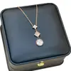 Nuevo Collar de Acero de Titanio con Concha Blanca de Trébol de Cuatro Hojas Más Vendido para Mujeres Estilo Ins Moda Versátil Nicho Joyería de Mano Dorada de 18K Que No Se Desvanece