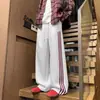 Atacado do fabricante calças de moletom esportivas listradas color block estilo americano para homens e mulheres, calças largas da moda, calças casuais versáteis de alta qualidade
