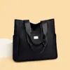 Bolsa tote feminina 2026 nova de grande capacidade em tecido Oxford, estilo simples para o dia a dia, bolsa de ombro com múltiplos bolsos, atacado