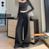 Foto real de traje de mujer de alta gama con caída, pantalones de pierna ancha, colección otoño 2026, con diseño de cintura de corbata, tiro alto, adelgazante, pierna recta, pantalones hasta el suelo