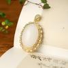 Colgante de huevo de jade dorado de Xinjiang con superficie de lujo con incrustaciones de jade Dongling Colgante de jade Regalo Joyería Venta al por mayor
