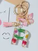 Suministros del Fabricante Llaveros con Flores Secas Prensadas 26 Letras del Alfabeto Inglés Llaveros con Borla de Mariposa Charms para Bolsos de Mujer