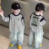 Camiseta de manga larga 100% algodón para niño, colección primavera y otoño 2026, estilo nuevo para niños mayores, camiseta base raglán para bebé, moderna
