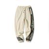 Calça masculina da moda 2022 outono e inverno Nova calça casual esportiva de moda jovem masculina solta plus size bordada com combinação de cores