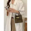 Bolso pequeño de mano con acabado mate texturizado para mujer, nuevo bolso tipo cubo retro otoño/invierno 2026, bolso de hombro/cruzado elegante y versátil