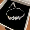 Set de pendientes, pulsera y anillo de mariposa y flor de circón ultra brillantes estilo ins coreano, accesorios de nicho de lujo ligero de alta gama