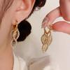 Exquisitos pendientes de estilo socialité, elegantes, con borlas de hojas de circón y hebilla de oreja, diseño de nicho, modernos y combinables, ligeros y lujosos.