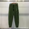 Calça Funcional da Marca Tendência Stone Island Transfronteiriça com Bolsos Laterais com Logo Estilo Americano Jogger Calça de Moletom Versátil Modelagem Solta Roupa de Trabalho