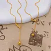 Tienda de Oro Mismo Estilo Oro Cepillado Ojo de Gato Borla Collar en Forma de Y para Mujer, Estilo Palacio Cadena Clavicular de Gama Alta