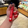 2026 Llavero Perro Rojo Pequeño Indestructible Más Vendido Colgante Perro Rojo Pequeño Herido Dedo Medio Maligno Regalo Venta al por Mayor