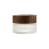 Botella de Vidrio con Grano de Madera Negra al por Mayor Botella Dispensadora de Cosméticos Botella para Crema de Mascarilla Esmerilada Botella para Crema de Ojos