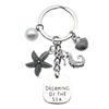 Llavero con concha de estrella de mar transfronterizo, colgante de aleación con gota de aceite, exquisito, para bolso de niña, llavero de perlas, regalo, joyería