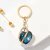 Moda Primaveral y Estival Hermoso Colgante de Llavero de Vidrio con Pedrería en Forma de Corazón Estereoscópico para Bolsos de Mujer Accesorios de Lujo