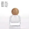 Venta al por mayor de botellas de perfume de vidrio transparente con formas únicas, botellas cilíndricas triangulares con base volcánica, botellas para sueros de cuidado de la piel y botellas con atomizador