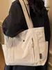Bolsa Feminina de Grande Capacidade Cor Lisa 2025 Inverno Nova Estilo Coreano Simples Bolsa Tote para Exterior Bolsa de Ombro de Alto Valor para o Dia a Dia