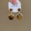 Brincos Olho de Tigre Estilo Melanoid Retro Senso de Design de Nicho Brincos Versáteis Luxo Leve Moda de Alta Qualidade Brincos de Tarraxa para Mulheres