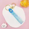 Llavero Colgante de Cordón de Cuero con Letra Transparente Brillante con Accesorios Estilo Muñeca Rellena de Aceite Encanto de Llavero Pulsera Venta al por Mayor