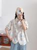 Camisa holgada de manga corta para mujer con estampado de grafiti fresco y dulce estilo japonés 2025 Top de verano al por mayor