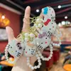 El llavero más vendido de Amazon con tachuelas de arcilla, gato KT 3D, cadena de perlas hecha a mano, un accesorio de alta gama para bolsos de mujer