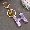 Venta caliente transfronteriza de moda 26 letras inglesas colgante de llave llavero de resina colgante creativo para bolsa de pareja