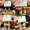 Pendientes de Aro Espiral con Circonita Zirconia Ultra-Hada Bañados en Oro Real Tacto de Alta Gama Cuentas Rojas Doble Gota de Agua Diseño de Nicho Ganchos para Oreja