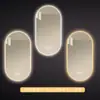 Espejo de baño inteligente ovalado para pared salón de belleza con luz pantalla táctil LED inducción antivaho espejo de tocador HD