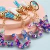 Llavero con 26 letras en inglés, estilo europeo y americano, con borlas de cristal acrílico transparente, adorno para bolso, pequeño regalo.