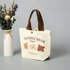 Bolsa de Lona con Oso Estilo Nuevo 2025 Bolsa Portátil para Almuerzo Bolso de Mano Artístico de Dibujos Animados Lindos Bolsa de Regalo para Mujeres