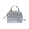 Bolsa Feminina Textura Moderna Comércio Exterior 2026 Nova Xadrez Concha Versátil Ombro Único Sobrancelha Bolsa de Mão para Senhoras