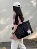 Transfronterizo 2026 principios de otoño nuevo nailon negro simple ligero doble bolsillo bolso de mano bandolera venta al por mayor