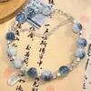 Livro de equitação vermelho explosivo azul e branco cor de porcelana combinando antiga borboleta Tassel pulseira de nicho feminino design estilo chinês ping an fu marca
