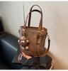 Bolsa de Mão Estilo Balde Moda Transfronteiriça para Mulheres Novo Estilo 2026 Bolsa de Ombro Simples Versátil Bolsa Casual Feminina Bolsa de Mão Estilosa