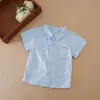Camisas Infantis 2026 Primavera e Verão Novas Estilo Coreano Algodão Puro Camisas Brancas Infantis para Crianças Pequenas e Médias com Gola Camisa Casuais Tops de Bebê