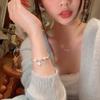 Corea del Sur nuevo brazalete elegante de perlas estrella para combinar con todo para mujer brazalete de diseño avanzado de nicho de lujo ligero venta al por mayor de brazaletes