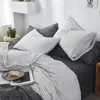 Juego minimalista de alta gama de cuatro piezas, sábana de algodón puro de grado A, funda de edredón, sábana bajera ajustable, ropa de cama simple de algodón lavado
