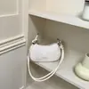 Bolso pequeño texturizado de alta calidad para mujer, nuevo bolso cruzado versátil de moda 2026, bolso cuadrado pequeño exquisito y súper popular de un solo hombro para debajo del brazo