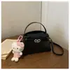 Mini bolso trapecio de estilo coreano con suave patrón de piedra, cierre metálico y decoración de cinturón, bolso cruzado de nicho