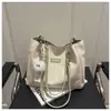 Bolsa de Ombro Versátil Feminina de Grande Capacidade Estilo Novo para Viagens Internacionais, Estudantes Universitários, Trabalho, Uso Casual, Moda de Nicho e Passeios Bolsa Tote