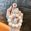 Corrente para celular com pingente de chaveiro de boneca pequena criativa nova, acessórios fofos para bolsa, chaveiro de carro, presente, atacado