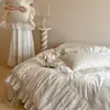 Juego de cuatro piezas de falda de cama de algodón de fibra larga ultrarresistente Clase A, estilo francés suave, juego de ropa de cama con funda nórdica de encaje jacquard 100% algodón