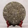 Té pu'er crudo de Yunnan de principios de primavera al por mayor Pastel de siete semillas de té de brotes tiernos de principios de primavera marrón punta de primavera 357g