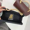Nuevo bolso de noche de lujo ligero transfronterizo para mujer, bolso de mano cilíndrico de color liso con asa de serpiente para fiestas de cóctel y banquetes